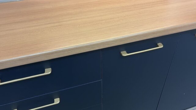 Close-up of modern fitted kitchen sets in a showroom - Interior design and home improvement concept