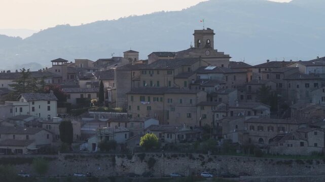 Aerial view of the medieval hilltop village of Montefalco featuring ancient stone buildings and a bell tower against rolling hills Montefalco, Umbria, Italy.