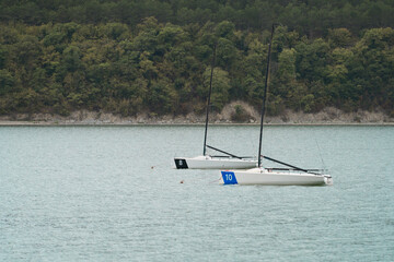 Two racing yachts at anchor in the middle of a mountain lake. © ROMAN DZIUBALO
