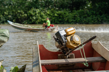 Obraz premium mazon river canoe with long-tail motor on a sunny tropical day