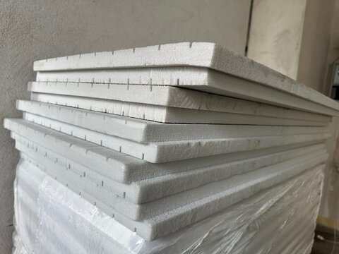 Expanded polystyrene cement sandwich panels indoors, closeup. Renovation material