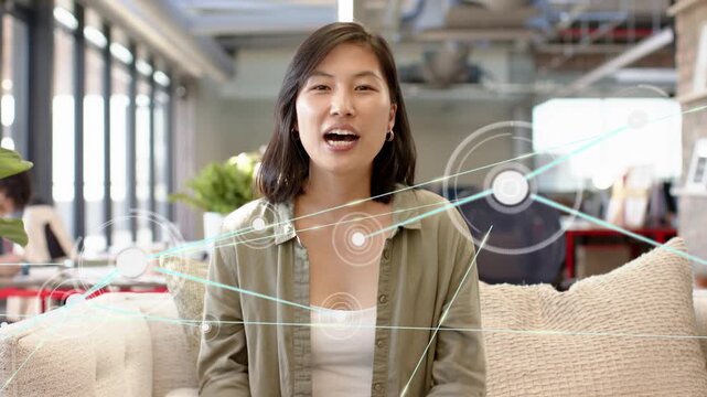 Woman adjusting hair, turning to camera and explaining tech, network nodes growing across frame