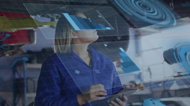 Vertical video: Inspecting tech in coverall prompted by lift, scanning underside using tablet HUD