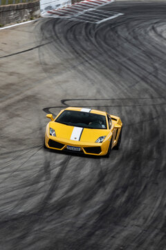 Yellow lamborghini gallardo front view on race track, Exotic luxury supercar racing