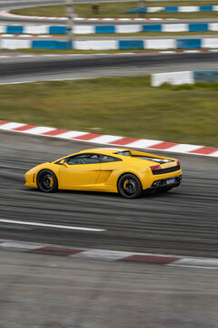 Yellow lamborghini gallardo side profile panning shot, Fast exotic supercar on race track