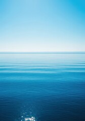 Obraz premium Vast deep blue marine water extending toward the endless horizon under a bright sunny day emphasizing natural tranquility and powerful open space, endless, calm, purity