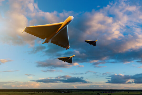 Aerospace defense, unmanned aerial vehicles fly in formation over open landscape, illustrating military aviation, surveillance technology and tactical flight operations