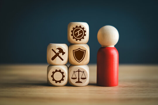 Red wooden peg doll standing next to wooden blocks with business and protection icons representing skills and attributes wooden figures peg dolls red figure personal growth attributes industry
