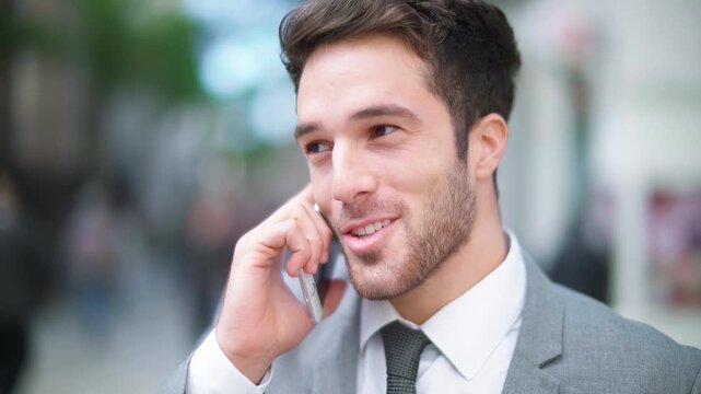 Close-Up Of A Smiling Businessman Talking On Smartphone Outdoors, Symbolizing Communication, Success, Networking, And Modern Business Interactions In An Urban Setting.