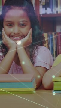 Vertical video: Two girls hands on face at library crop shifting nodes linking over books for study