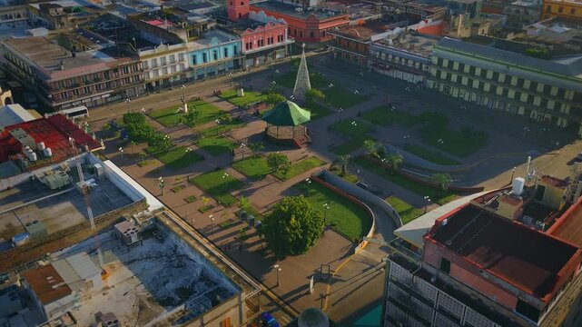 Plaza de la Libertad Featuring the Green Kiosk and French Style Historic Architecture during a Peaceful Sunrise in the Historic Center of Tampico Tamaulipas Mexico Cinematic Aerial Drone Dolly In with