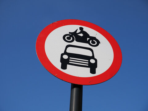 No motor vehicles allowed road traffic red circle sign of motorbike above car, UK