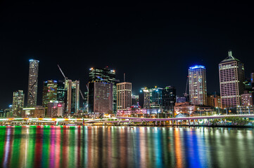 Fototapeta premium Brisbane skyline at night with colorful reflections on Brisbane River,