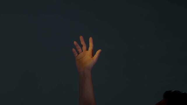 Conceptual hand movements and graceful finger gestures under vibrant colored neon light, artistic palm motion in studio with blue and red cinematic lighting, expressive hands against dark background.