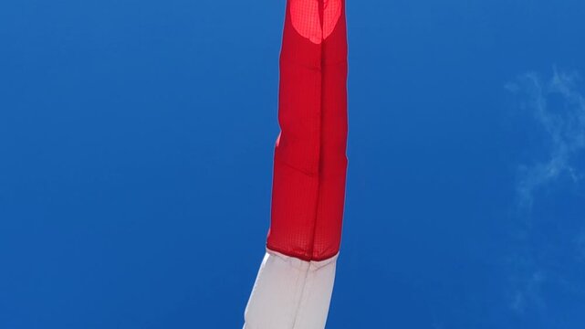 Red and white windsock - wind vane. Red and white windsock with arrow - wind vane