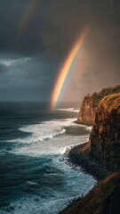 Naklejka premium Rainbow Over Rocky Coastline at Dusk