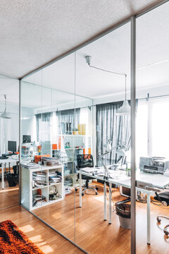 Bright modern office interior with glass walls and desks