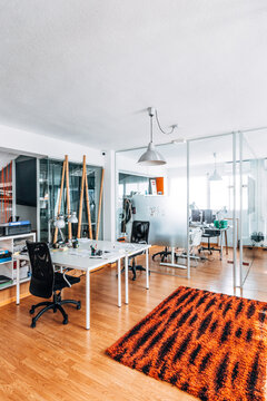 Modern open plan office with glass partitions and desks