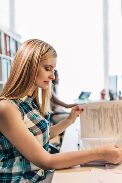 Young professional reviewing documents in modern office