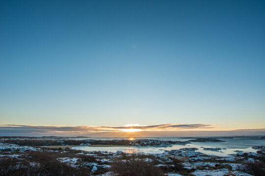 Blue pedestrian crossing road sign indicating safe walking area in city.