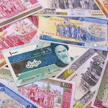 Iranian rial money bills pile on table. Iran banknotes of IRR currency close up.