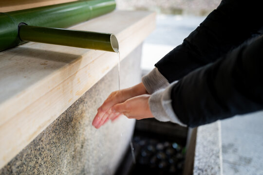 Ceremony of washing your hands before entering a shrine in Tokyo, Japan.