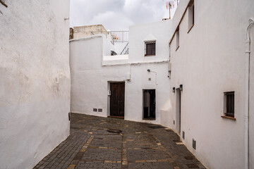 Deserted alley with whitewashed houses and stone paving in Vejer de la Frontera © Andrea Tabaro