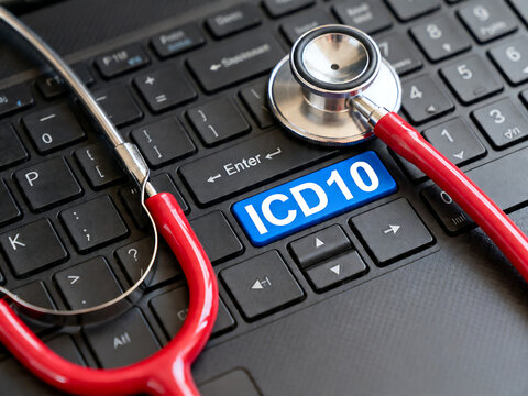 ICD 10 medical coding key on laptop keyboard, red stethoscope on computer for healthcare billing, digital health records and insurance claims isolated on White Background