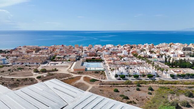 vacation horizon town coast city beach rural urban architecture sea view greenhouse invernaderos agriculture intensive farming summer blue sky - Balerma, Andalusia, Spain - 2025