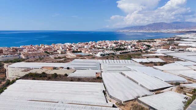 plastic sea summer coast travel industry rural town beach sea agriculture field greenhouse invernaderos architecture city urban border blue cloudscape drone - Balerma, Andalusia, Spain - 2025