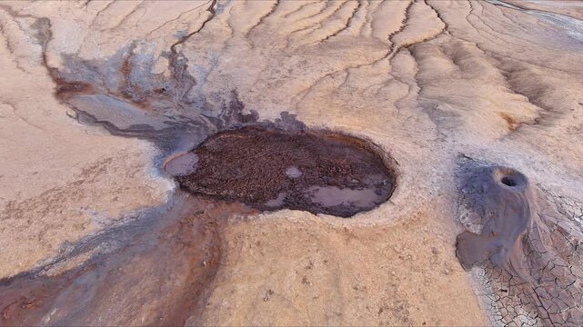 Aerial view of Vulcanii Noroiosi Paclele Mici mud volcanoes with bubbling mud and eroded clay landscape in Scortoasa, Buzau County, Romania.