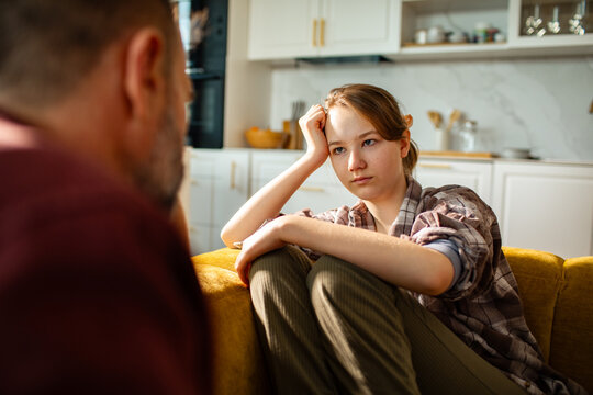 Teen and adult having serious conversation at home