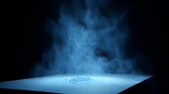 Dynamic blue powder explosion creating abstract cloud effect on dark background, intense energy and movement.