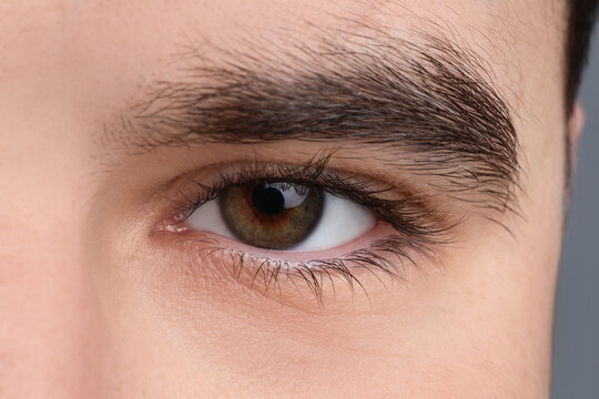 Young man with beautiful hazel eyes. Closeup