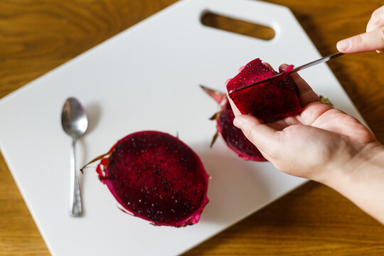 Woman holding dragon fruit. Mother serving fruit complementary food for baby. Family domestic life. Mom and son having dinner together