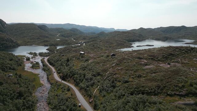 Peaceful place next to the road in Norway full of spring water in river in summer