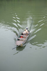 Fototapeta premium Fisherman in boat, Vietnam Editorial use only