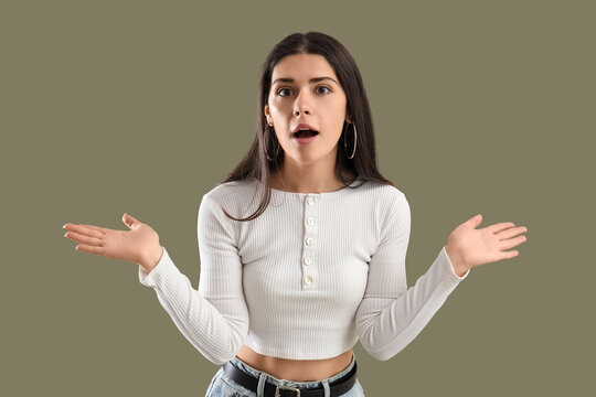 Young gossip woman on green background