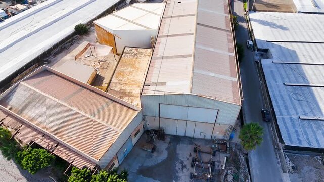 industrial building drone roof industry old metal warehouse factory abandoned sunlight summer business restoration project aerial urban rural country - Andalusia, Spain - 2025