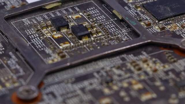 Close-up of a detailed computer circuit board. This footage is ideal for technology, engineering, and digital-themed content.
