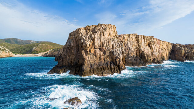 Aerial view of the limestone cliffs of Cala Domestica in Buggerru, Sardinia, Italy