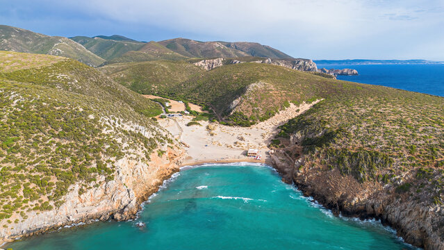 Aerial view of the turquoise waters and limestone cliffs of Cala Domestica beach in Buggerru, Sardinia, Italy