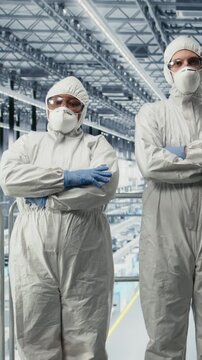 Vertical video Monitoring PCB smart factory workflow, EDA software on display and portrait of engineering team. Tracking microchip production circuit layout defects, simulation application and