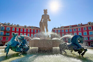 Close view of Fountain of the Sun at Place Massena in Nice, France. Water splashes and sculptures create dynamic scene of famous French Riviera landmark. © Tatiana