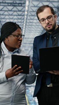 Vertical video Optimizing workflow, microchips and woman with coworker using EDA software in smart factory. Using simulation tool, semiconductors and teamworking colleagues tracking circuit layout