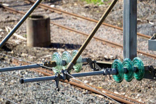 Railway Glass Insulators Electrical Infrastructure Train Power Lines Overhead Catenary System High Voltage Component Track Maintenance Engineering Power Distribution Public Transport