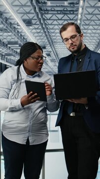 Vertical video Optimizing workflow, microchips and woman with coworker using EDA software in smart factory. Using simulation tool, semiconductors and teamworking colleagues tracking circuit layout