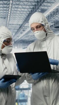 Vertical video Developing microchips, advanced electronics automation and EDA engineers in smart factory. Optimizing semiconductor design flow, simulation software and experts using devices, camera B