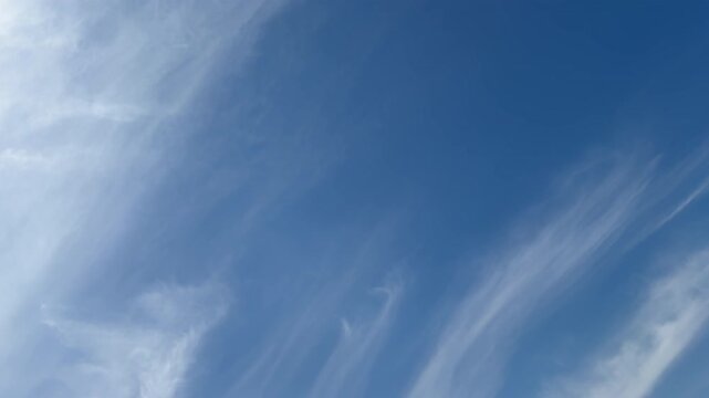 Wispy cirrus clouds in blue sky with copy space, airy sky background