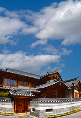 Fototapeta premium Tranquil summer cloudscape over Korean traditional house district at Eunpyeong Hanok Village in Seoul, South Korea